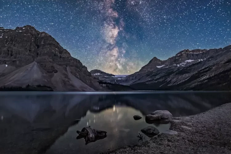 The galactic centre region of the Milky Way in Sagittarius setting behind Bow Glacier at the end of Bow Lake